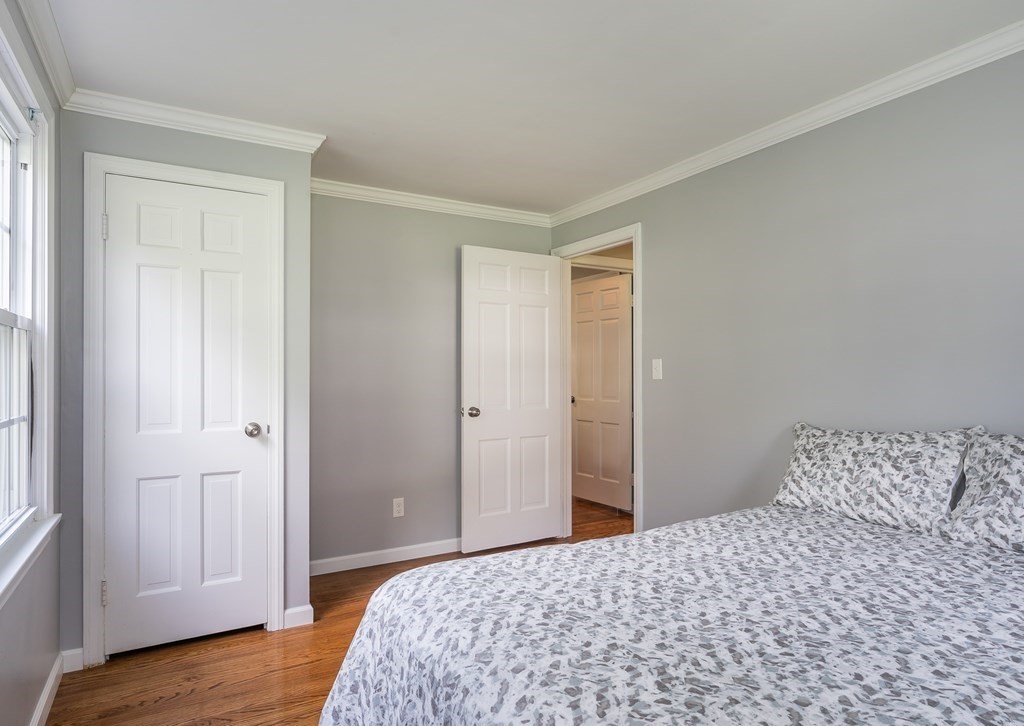 2 East Colonial Road Wilbraham, MA 01095 - Photo 20 of 42 a bedroom with a bed and wooden floor