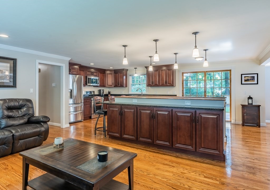 2 East Colonial Road Wilbraham, MA 01095 - Photo 5 of 42 a living room with stainless steel appliances furniture a rug and a view of kitchen