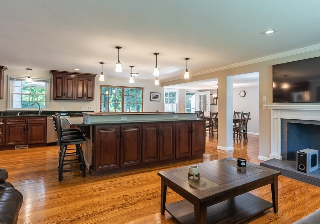 2 East Colonial Road Wilbraham, MA 01095 - Photo 7 of 42 a living room with furniture a flat screen tv and kitchen view