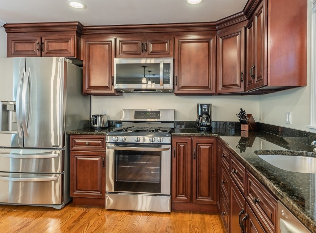 2 East Colonial Road Wilbraham, MA 01095 - Photo 9 of 42 a kitchen with stainless steel appliances granite countertop a refrigerator stove and sink