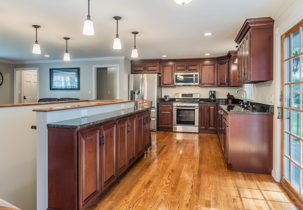 2 East Colonial Road Wilbraham, MA 01095 - Photo 10 of 42 a large kitchen with stainless steel appliances granite countertop a stove a sink dishwasher a refrigerator and wooden cabinets with wooden floor