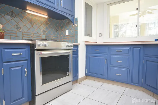 a stove top oven sitting inside of a kitchen