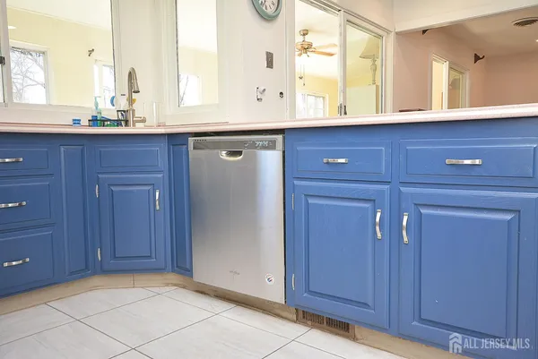a kitchen with a sink cabinets and window