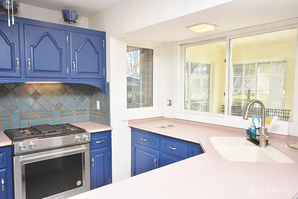 a spacious bathroom with a tub sink and mirror