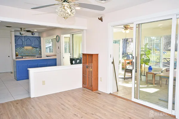 a view of kitchen with livingroom and wooden floor