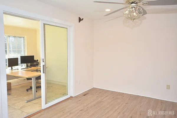 a workspace with wooden floor and windows