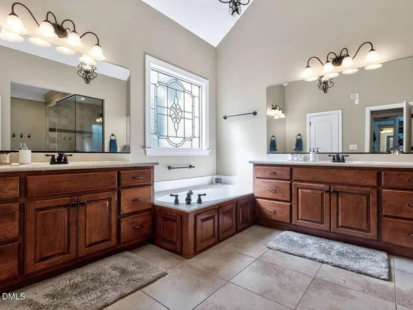 a bathroom with a granite countertop sink a toilet and shower