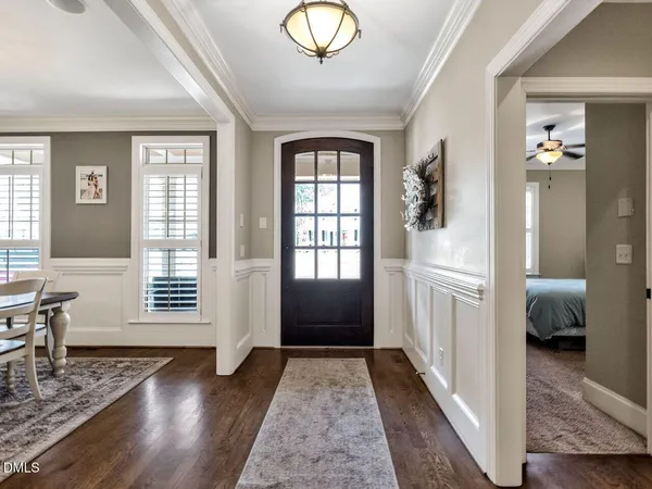 a dining room with furniture a chandelier and window