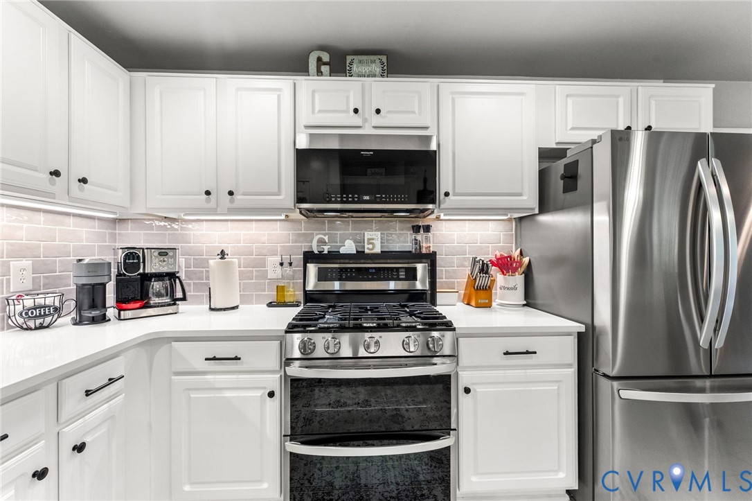 3120 Denise Road Petersburg, VA 23805 - Photo 22 of 51 White cabinetry with black hardware, white counter