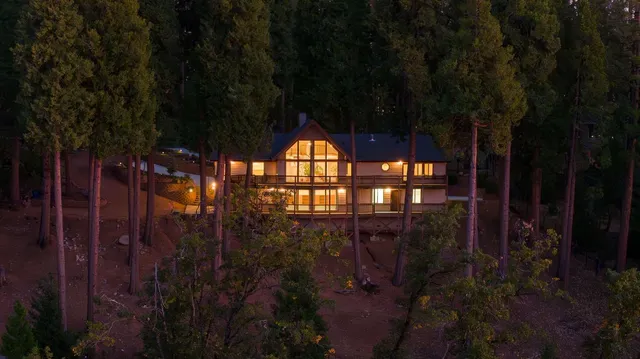 a large kitchen with kitchen island a stove a sink dishwasher and cabinets with wooden floor