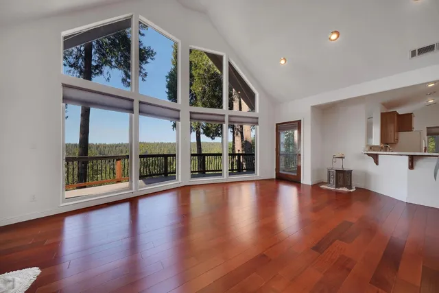 a kitchen with stainless steel appliances kitchen island wooden cabinets and fireplace