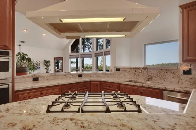 a spacious bedroom with a large bed and a chandelier fan