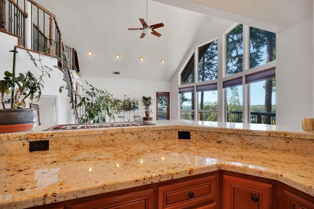 a spacious bedroom with a large bed and a flat tv screen