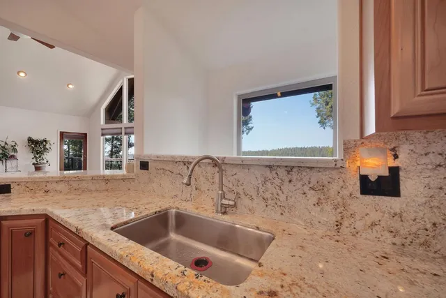 a bathroom with a granite countertop bathtub and shower