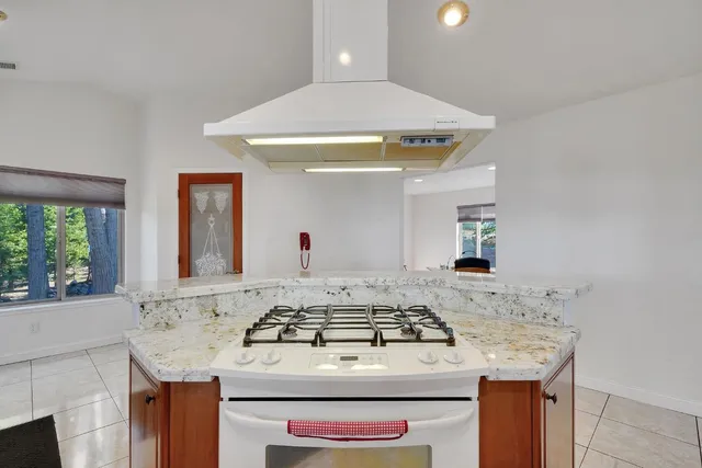 a bathroom with a granite countertop sink and mirror