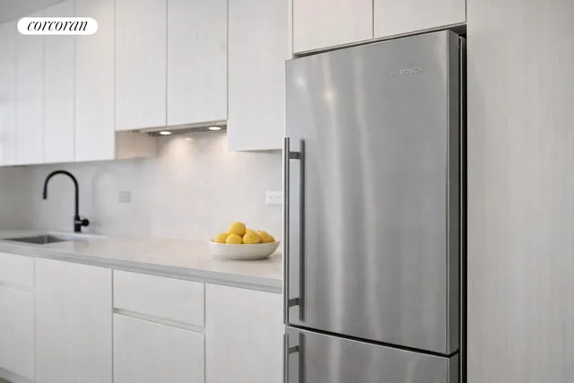 a close view of a sink and cabinets in the kitchen