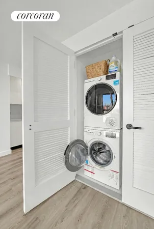 a utility room with washing machine and a view of bedroom