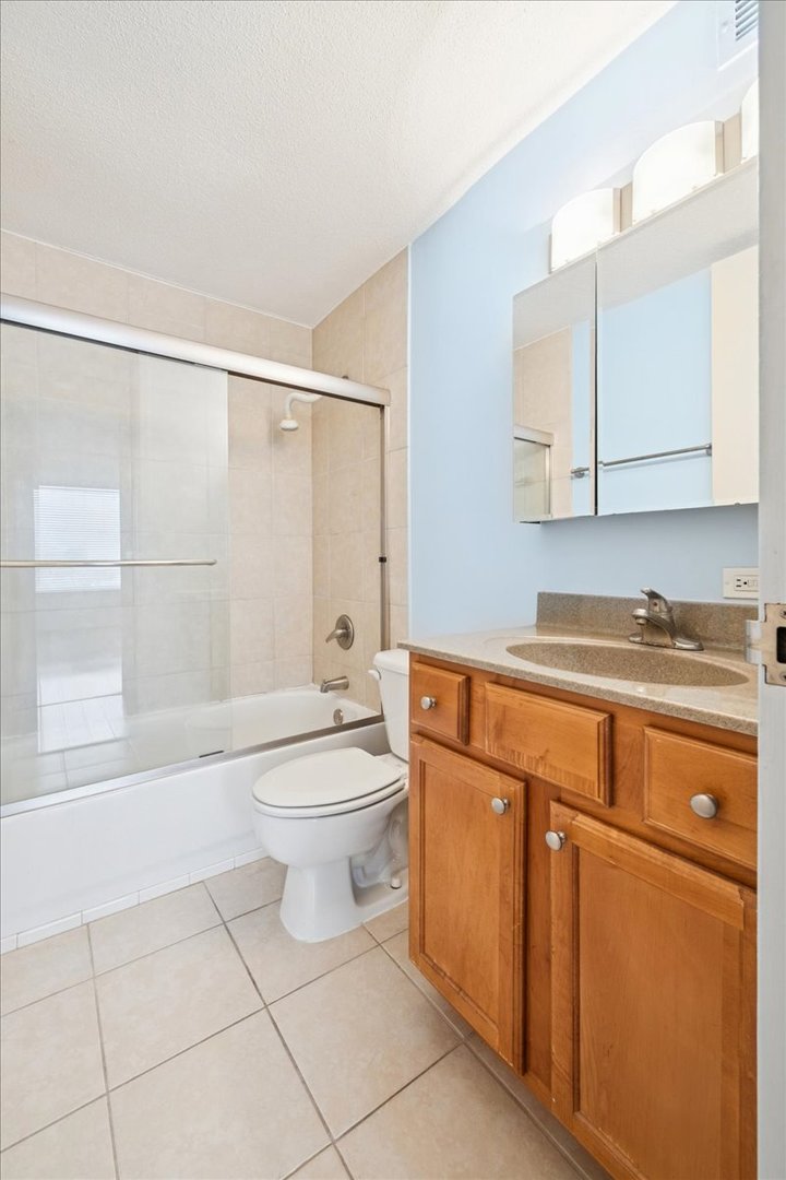 2728 North Hampden Court, Unit 910 Chicago, IL 60614 - Photo 11 of 15 a bathroom with a sink a toilet and shower