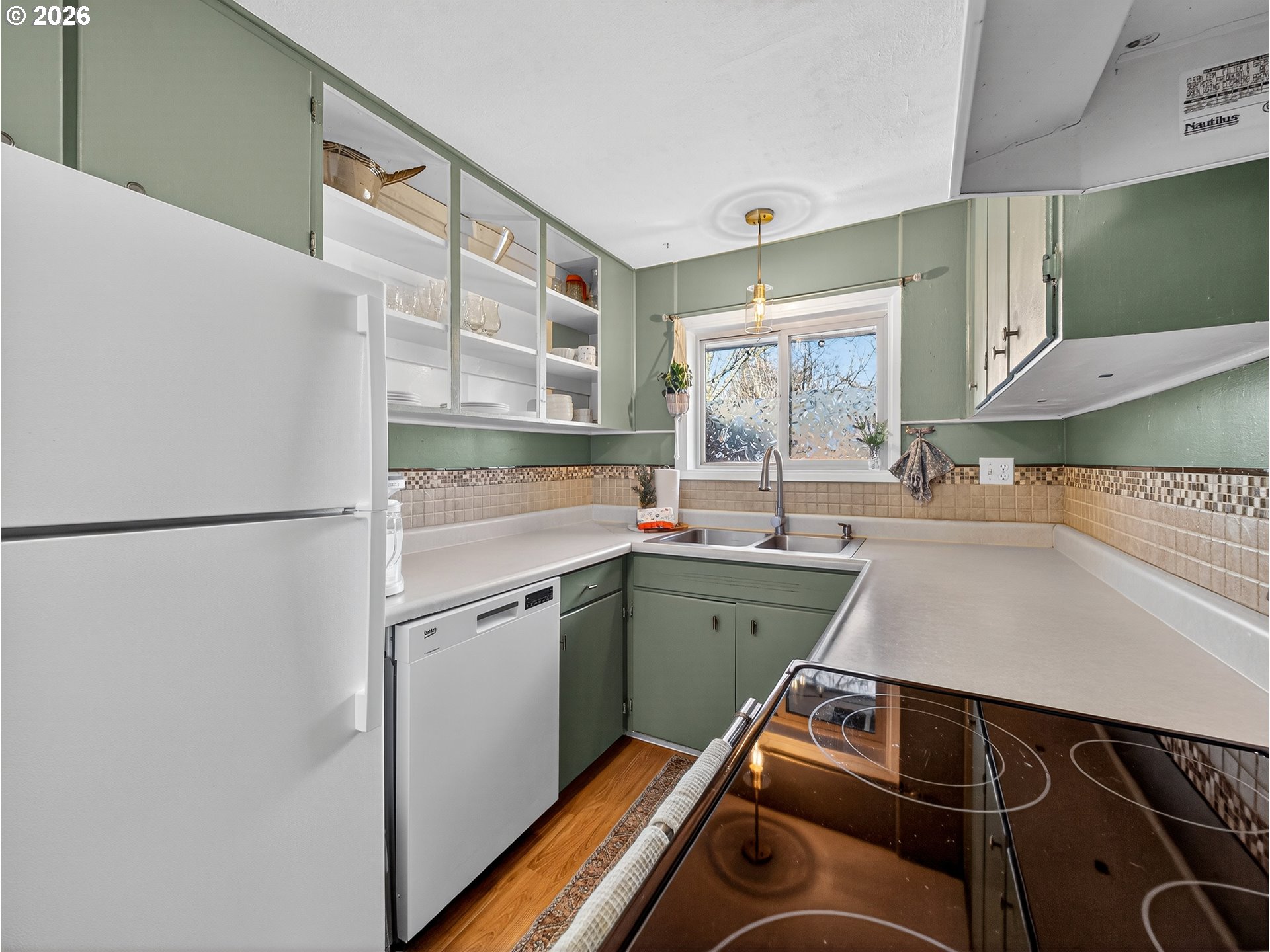 2230 Cleveland Street Eugene, OR 97405 - Photo 17 of 37 a kitchen with a refrigerator and a sink
