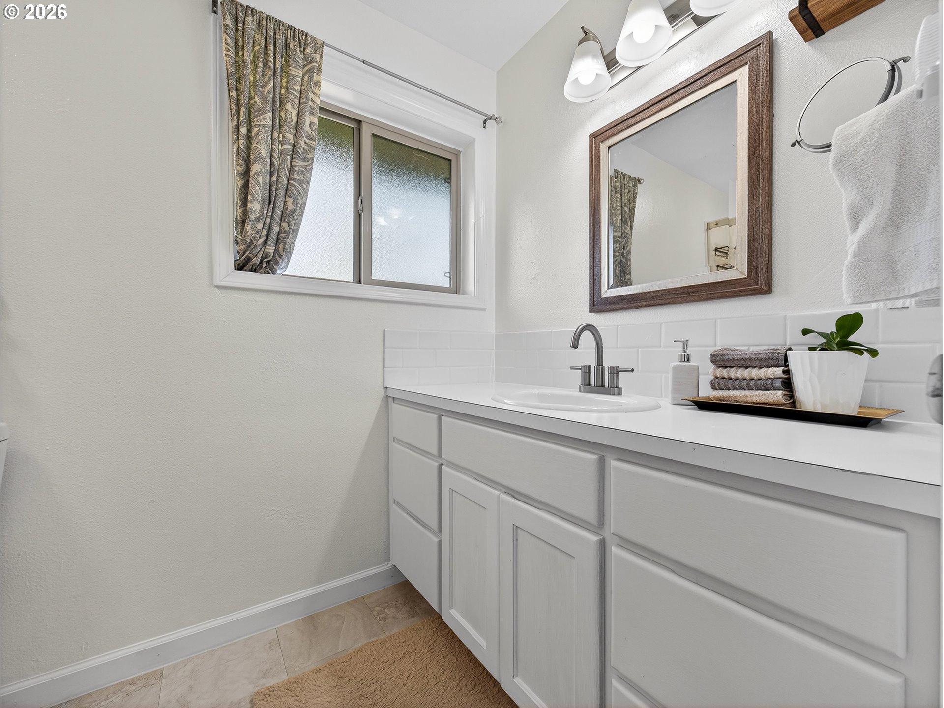 2230 Cleveland Street Eugene, OR 97405 - Photo 23 of 37 a bathroom with a sink mirror and vanity