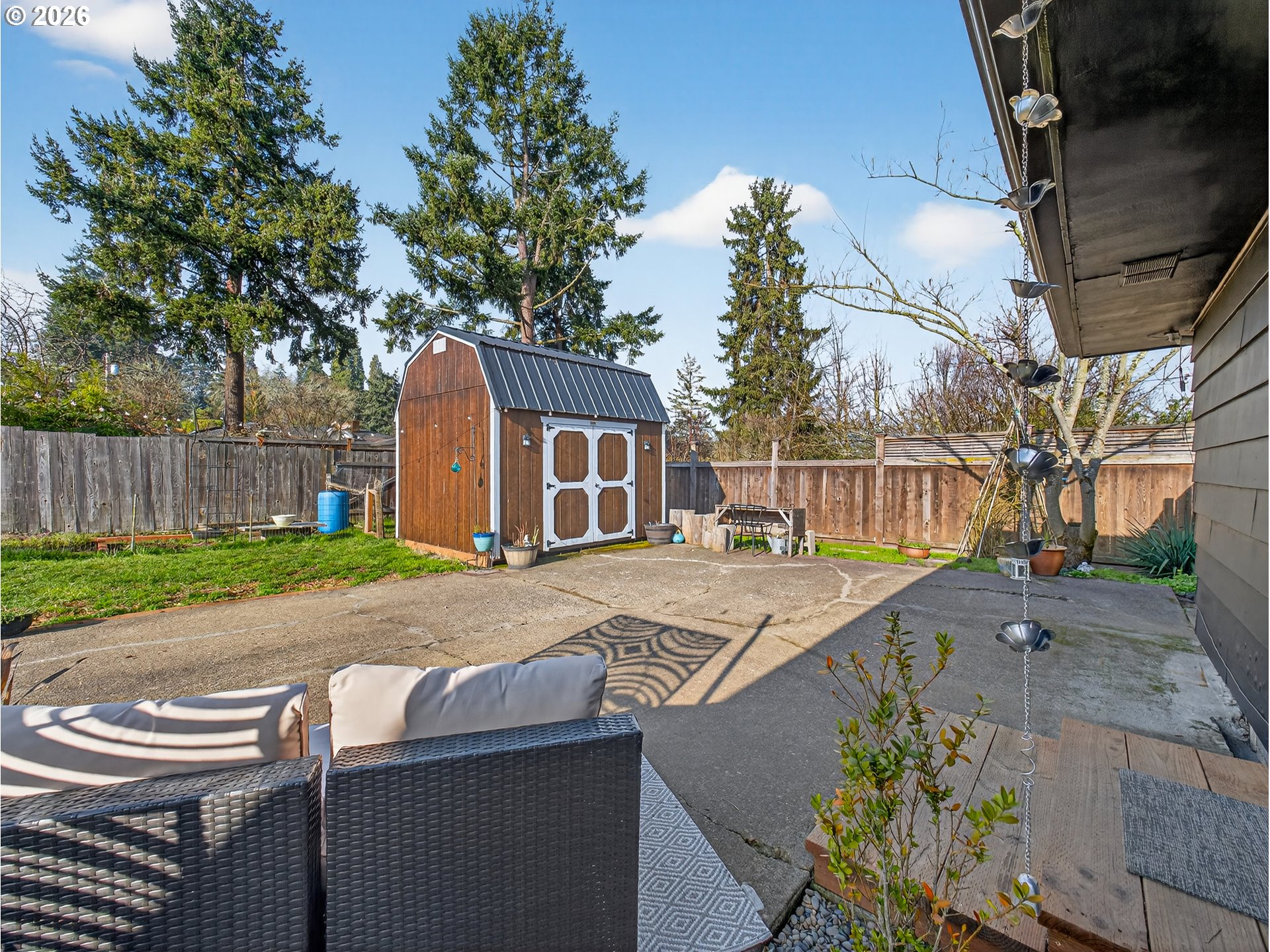 2230 Cleveland Street Eugene, OR 97405 - Photo 31 of 37 a view of a backyard with table and chairs and wooden fence