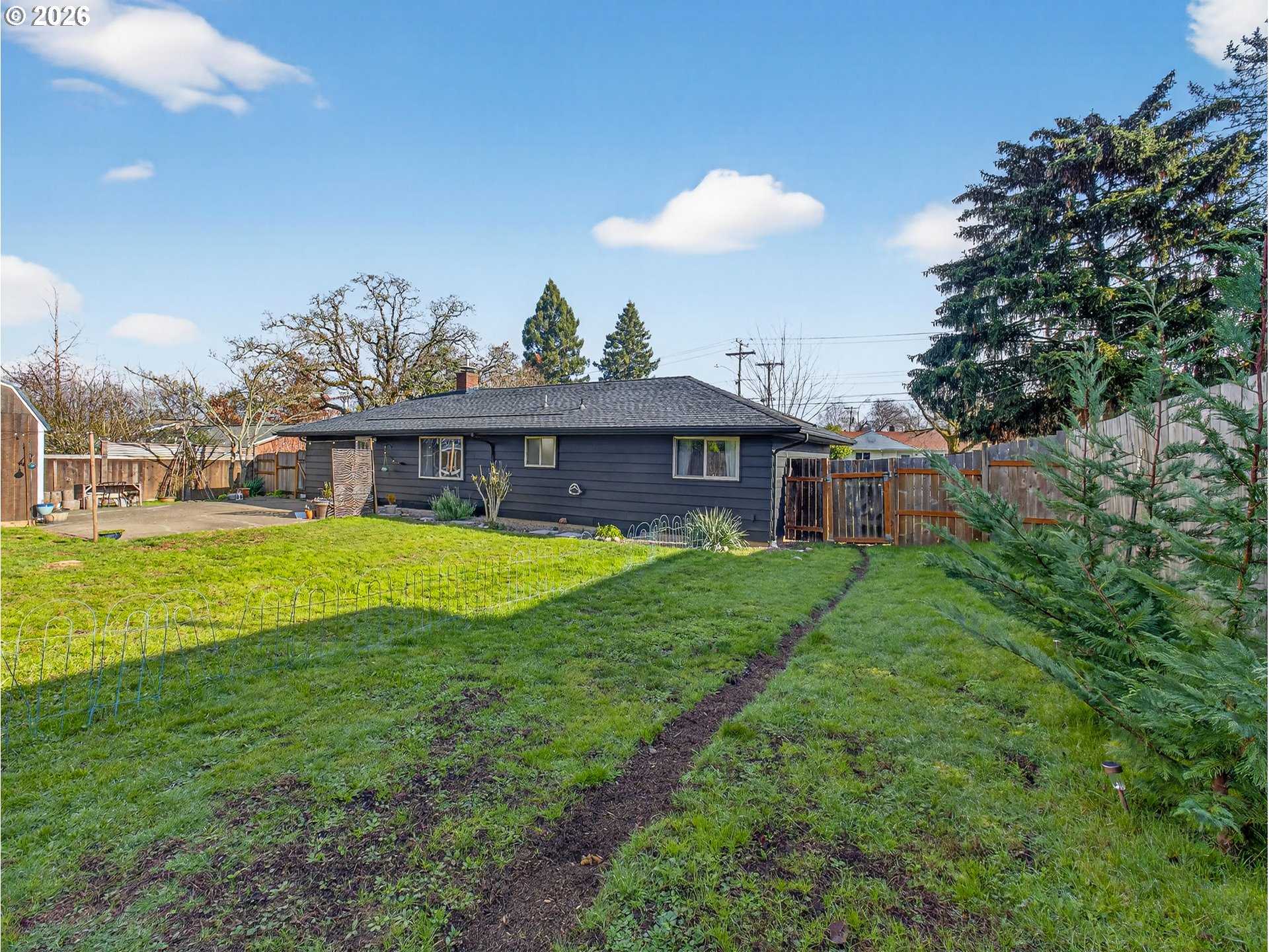 2230 Cleveland Street Eugene, OR 97405 - Photo 35 of 37 a view of a house with a backyard and a garden