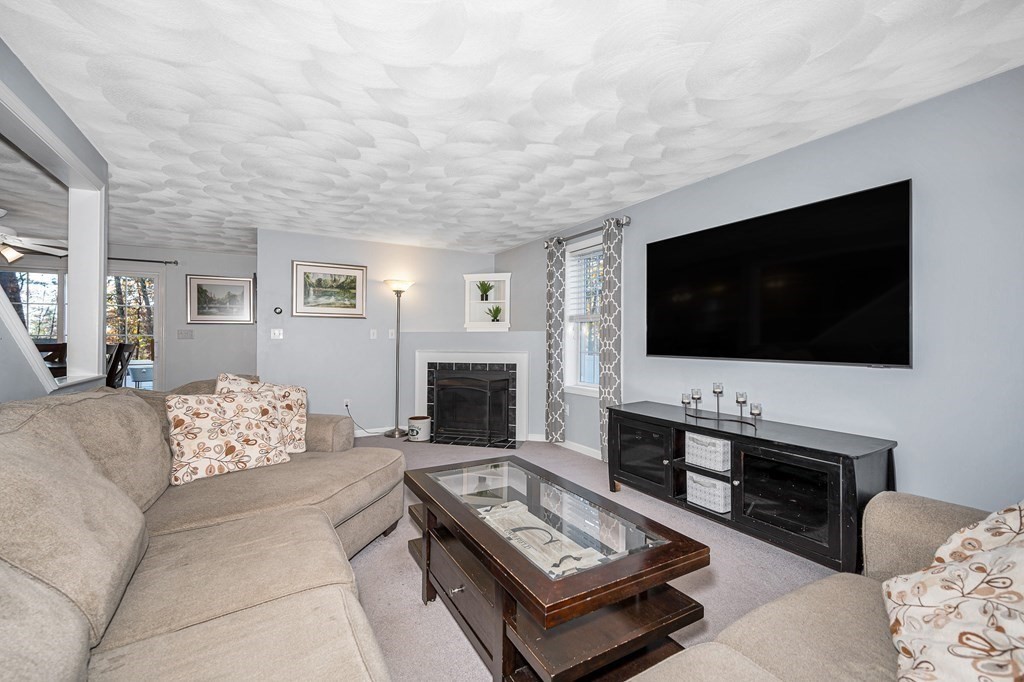 46 Parham Road Tyngsboro, MA 01879 - Photo 13 of 36 a living room with furniture and a flat screen tv