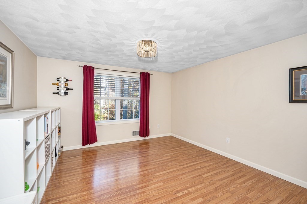 46 Parham Road Tyngsboro, MA 01879 - Photo 14 of 36 a view of an empty room with wooden floor and a window
