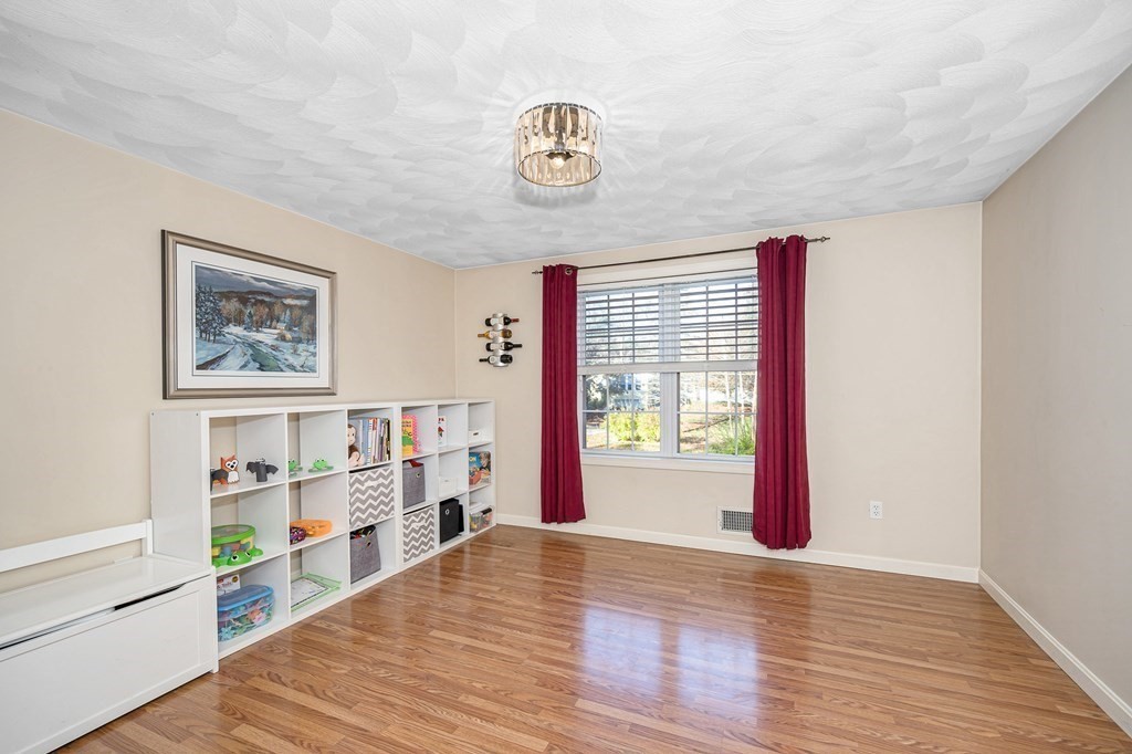 46 Parham Road Tyngsboro, MA 01879 - Photo 15 of 36 a view of an empty room with window and wooden floor