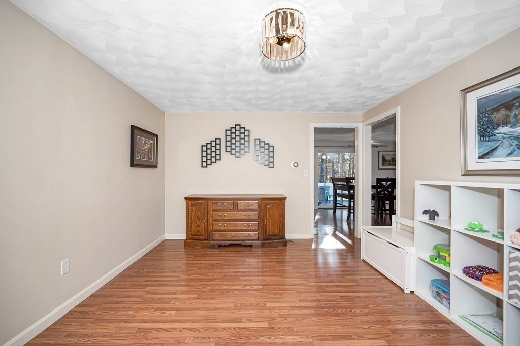 46 Parham Road Tyngsboro, MA 01879 - Photo 16 of 36 a view of an empty room with bookshelf and wooden floor