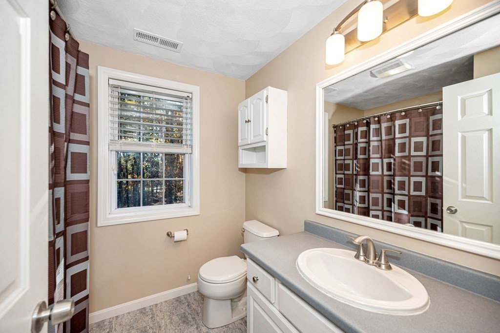 46 Parham Road Tyngsboro, MA 01879 - Photo 23 of 36 a bathroom with a sink and a mirror