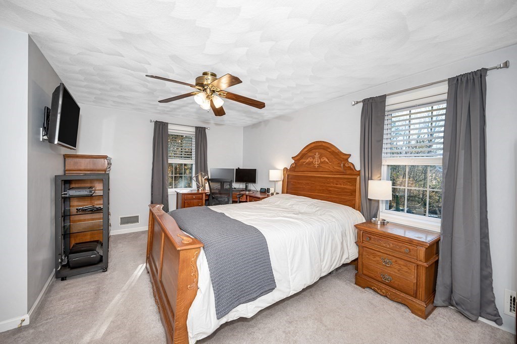 46 Parham Road Tyngsboro, MA 01879 - Photo 24 of 36 a bedroom with a bed and a chandelier