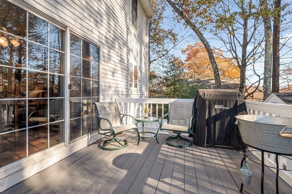 46 Parham Road Tyngsboro, MA 01879 - Photo 32 of 36 a view of a patio with table and chairs and wooden floor