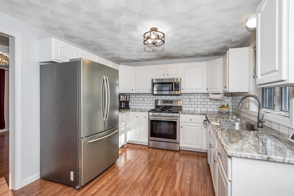 46 Parham Road Tyngsboro, MA 01879 - Photo 4 of 36 a kitchen with stainless steel appliances granite countertop a refrigerator stove and sink