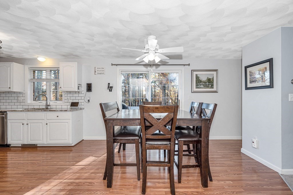 46 Parham Road Tyngsboro, MA 01879 - Photo 7 of 36 a dining room with wooden floor a chandelier a wooden table and chairs