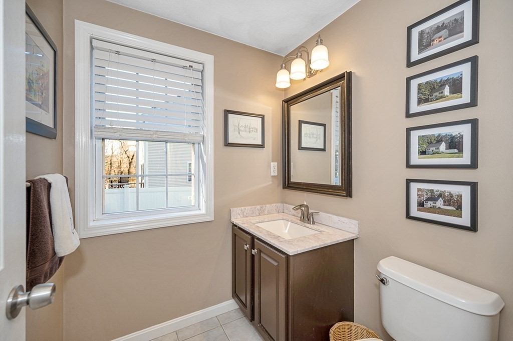 46 Parham Road Tyngsboro, MA 01879 - Photo 8 of 36 a bathroom with a toilet sink and mirror