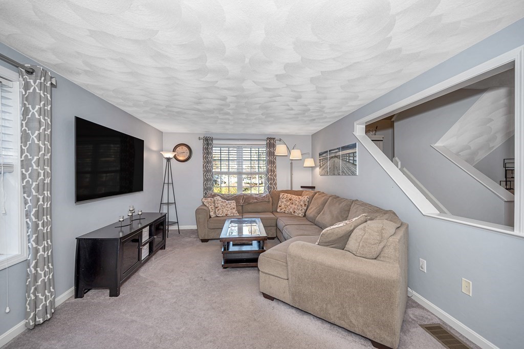 46 Parham Road Tyngsboro, MA 01879 - Photo 10 of 36 a living room with furniture and a flat screen tv