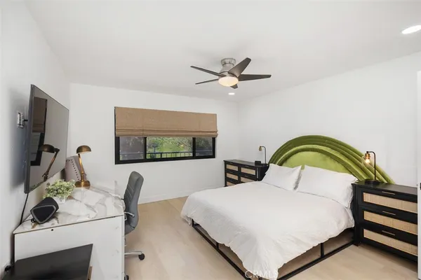 a bedroom with a bed and a flat screen tv