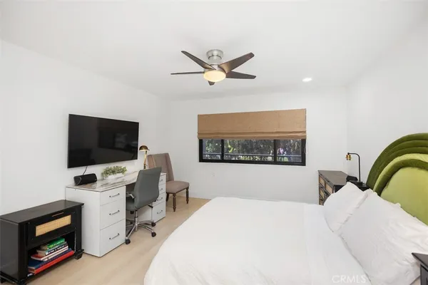 a bedroom with a bed and a flat screen tv