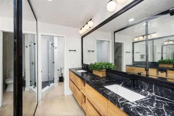 a large bathroom with a granite countertop double vanity sink and a mirror