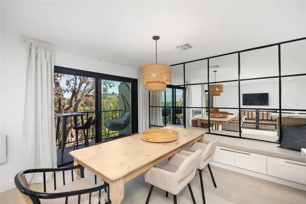 a kitchen with a table chairs and wooden floor
