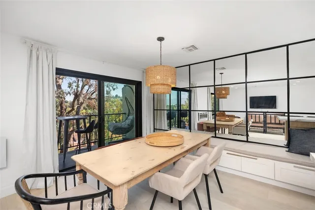 a kitchen with a table chairs and wooden floor