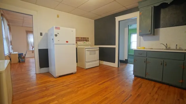 a kitchen with a refrigerator and cabinets