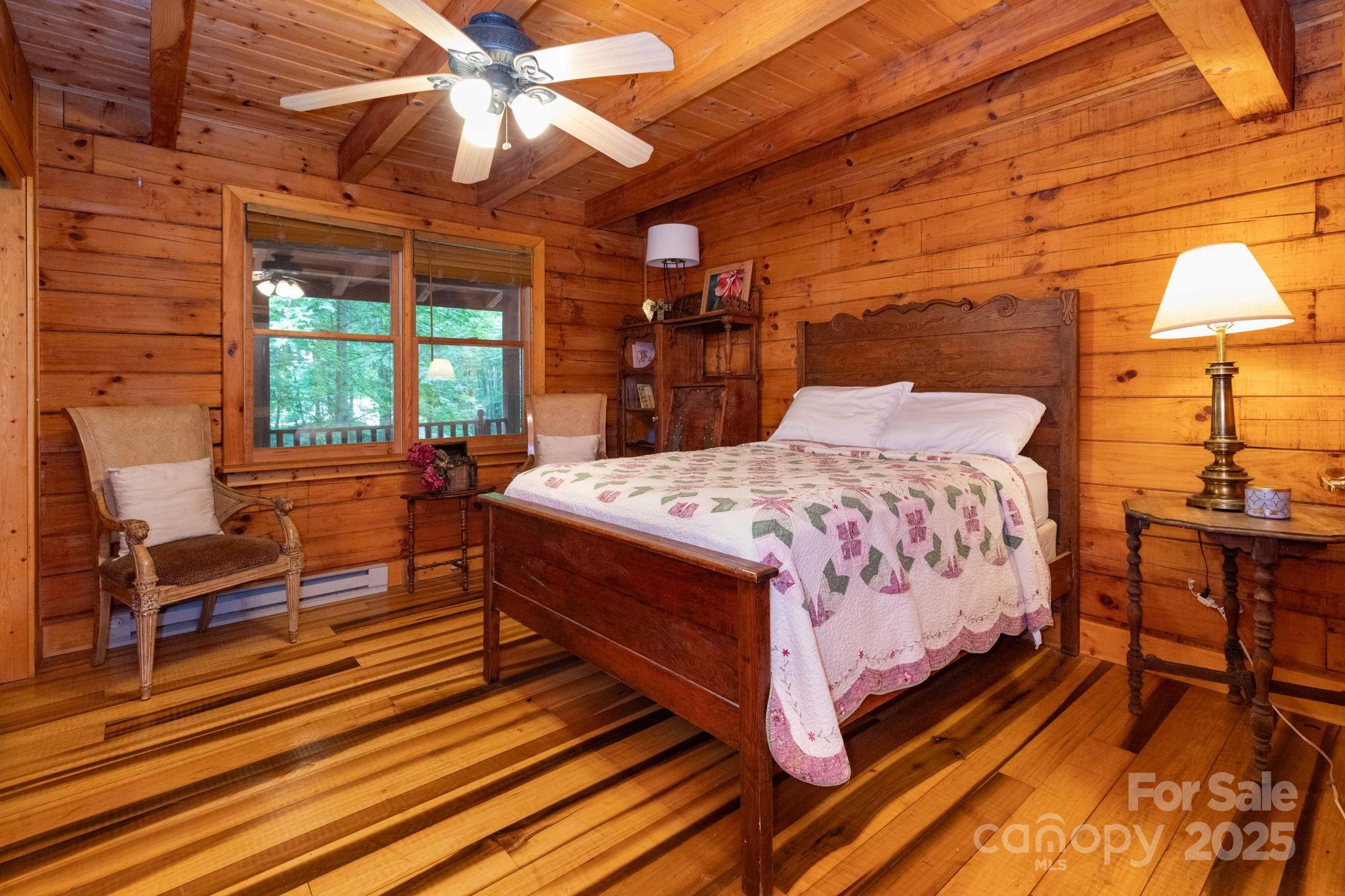 192 Granny Shepherd Road Mars Hill, NC 28754 - Photo 11 of 26 a bedroom with a bed and wooden floor