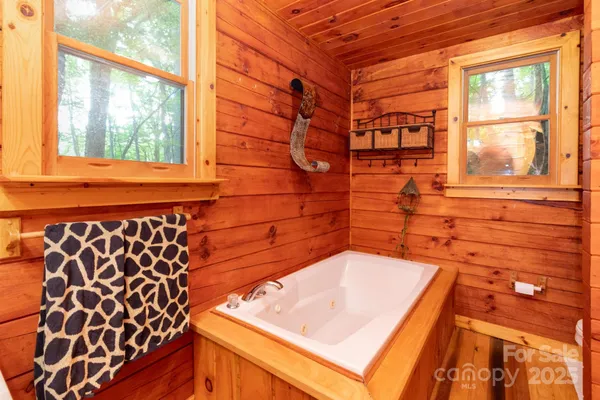 a bathroom with a bathtub and window