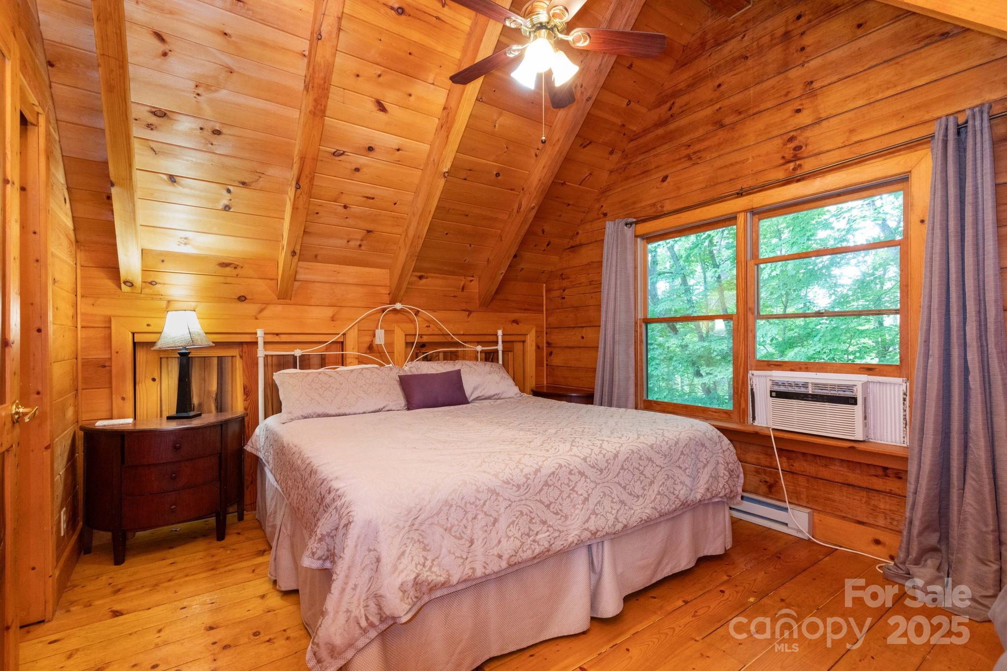 192 Granny Shepherd Road Mars Hill, NC 28754 - Photo 16 of 26 a bedroom with a bed and a window
