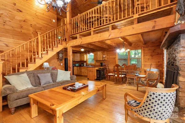 a roof deck with couches and wooden fence