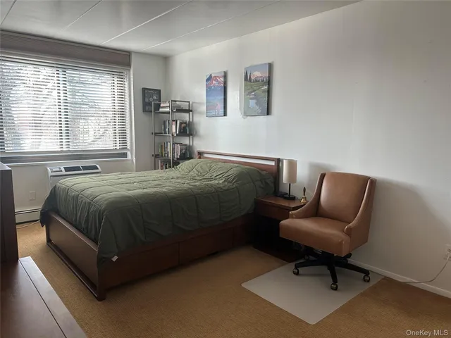 a bedroom with a bed and a chair in it