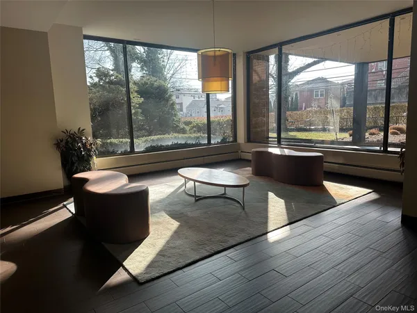 a living room with couches a coffee table and a large window with outer view