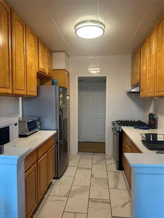 a kitchen with a sink a stove and a refrigerator